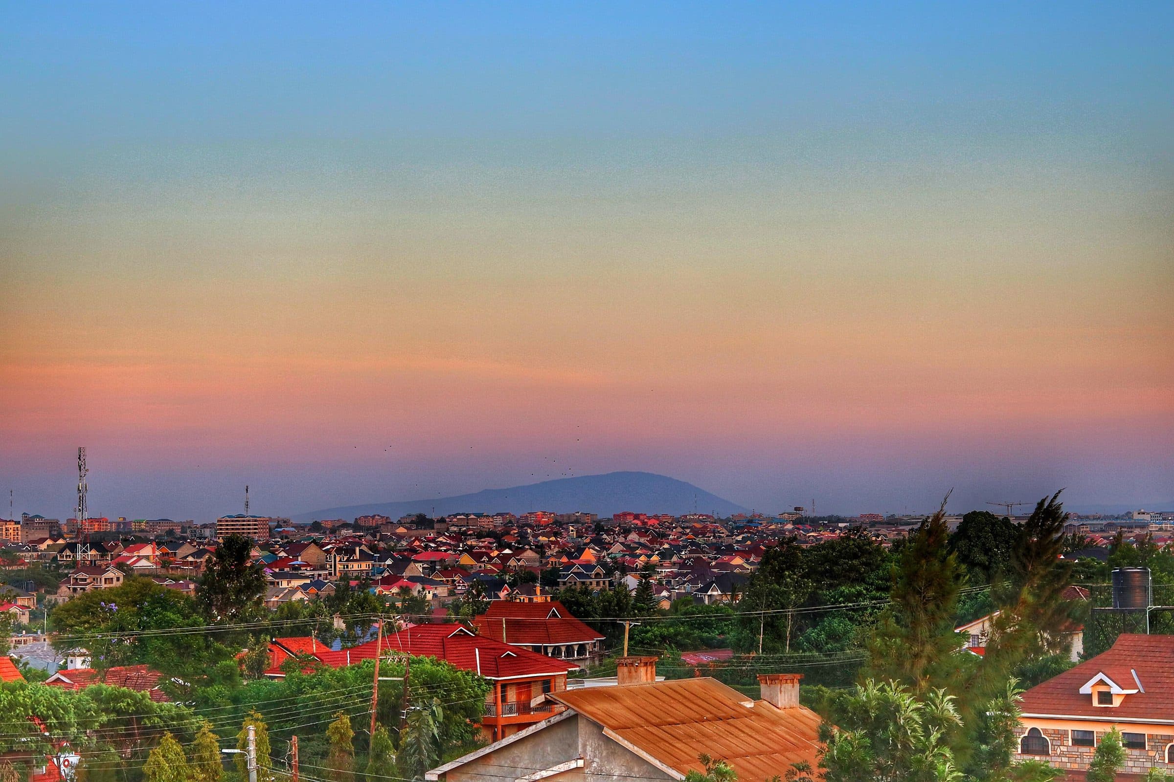 Mt. Kilimambogo on the horizon at sunset, seen across the town below